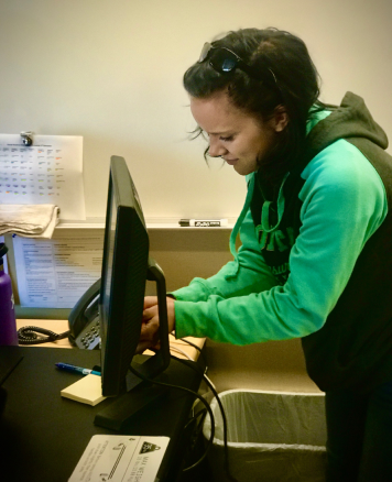 Sophomore Ash Ayers replaces a monitor for a teacher at Silverton High School. She is one of around a dozen students who are paid to assist with the school district’s IT tickets.